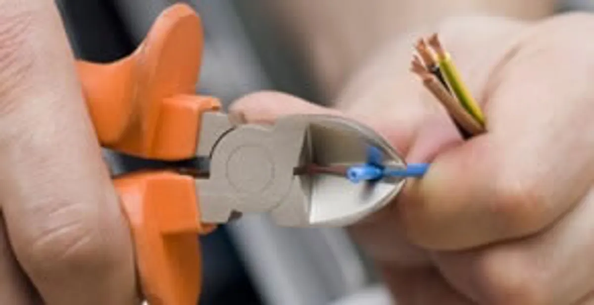 professional electrical services showing precise wire cutting by licensed electricians in Spokane, WA